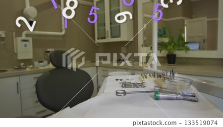 Displaying dental instruments resting on sterile tray in clinic operatory, with floating overlay Displaying dental instruments resting on sterile tray in clinic operatory, with floating overlay 133519074