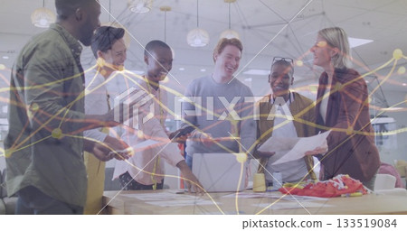 Group of six office professionals collaborating around table in office, with charts, sneakers Group of six office professionals collaborating around table in office, with charts, sneakers 133519084