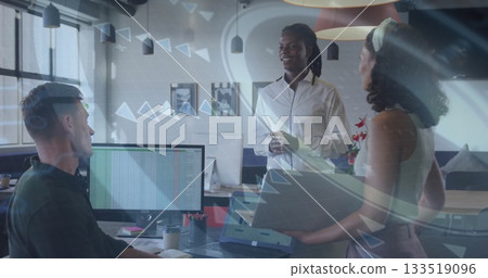 Gathering three coworkers in business attire discussing spreadsheet in office, with laptop 133519096