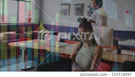 Focusing teenage white woman typing on laptop in coworking space, with floating data overlays 133519097