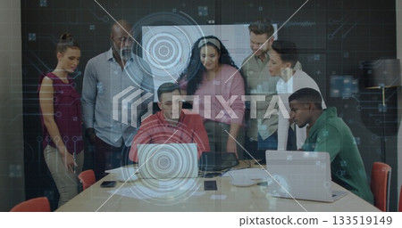 Collaborating seven professionals examining holographic overlay at conference table, with laptops Collaborating seven professionals examining holographic overlay at conference table, with laptops 133519149
