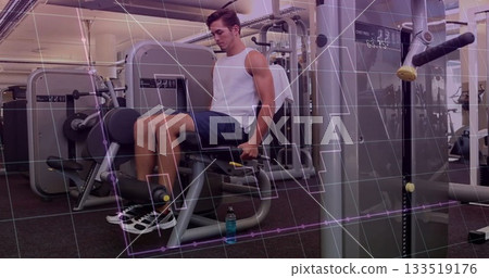 Performing leg extensions on machine man wearing white shirt, dark shorts at gym with water bottle Performing leg extensions on machine man wearing white shirt, dark shorts at gym with water bottle 133519176
