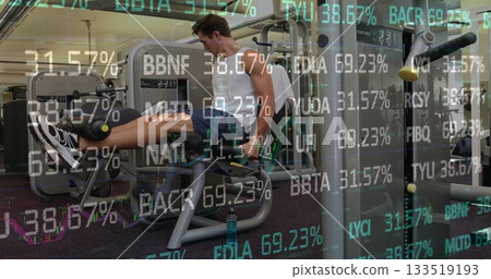 Extending legs on leg extension machine at fitness center wearing sportswear and financial overlays Extending legs on leg extension machine at fitness center wearing sportswear and financial overlays 133519193