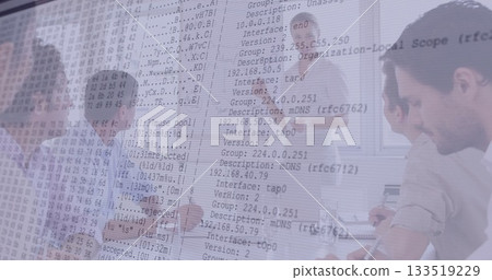 Collaborating IT professionals analyzing network data in meeting room, with laptops and flip chart 133519229