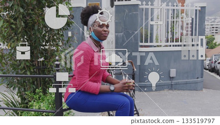 Sitting masked woman wearing pink sweater sipping takeout coffee on sidewalk, with bicycle, icons 133519797