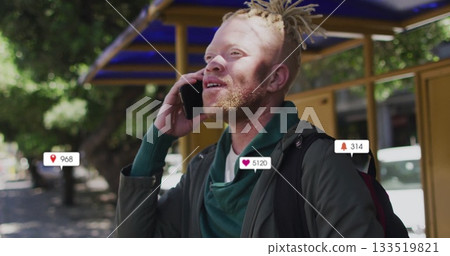 Talking Black man holding smartphone and carrying backpack at bus shelter, with notification icons Talking Black man holding smartphone and carrying backpack at bus shelter, with notification icons 133519821