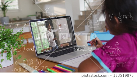 Student in fuchsia shirt writing geometry notes in notebook at home desk with laptop, copy space 133519873