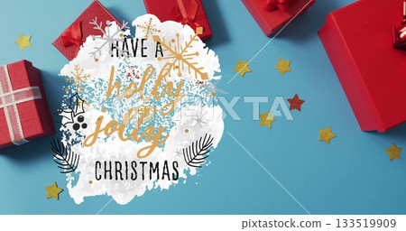Featuring paint-splash Christmas greeting at craft table with red gift boxes and gold star confetti Featuring paint-splash Christmas greeting at craft table with red gift boxes and gold star confetti 133519909