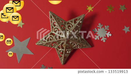 Featuring gold glitter star ornament on red table, with silver cutouts and yellow envelope icons Featuring gold glitter star ornament on red table, with silver cutouts and yellow envelope icons 133519913