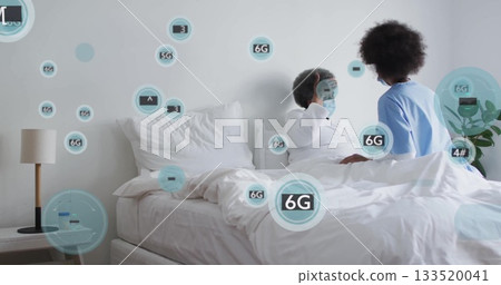 Reclining patient receiving care from caregiver in scrubs on bed in bedroom, with 6G icons 133520041
