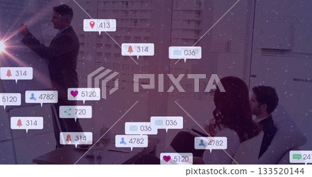 Presenting businessman wearing navy suit using glass board in conference room, with floating icons 133520144