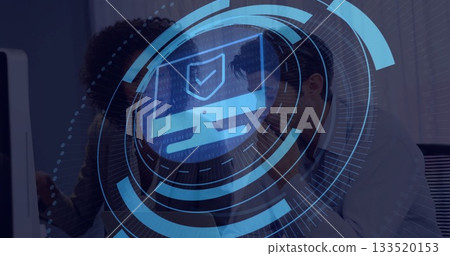 Reviewing cybersecurity overlay specialist and analyst in blazer working at office desk shield icon 133520153