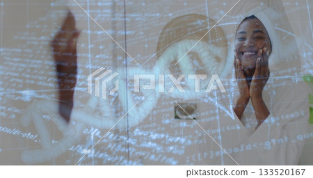 Applying cream woman wearing robe massaging cheeks in bathroom, DNA helix code streams, copy space Applying cream woman wearing robe massaging cheeks in bathroom, DNA helix code streams, copy space 133520167
