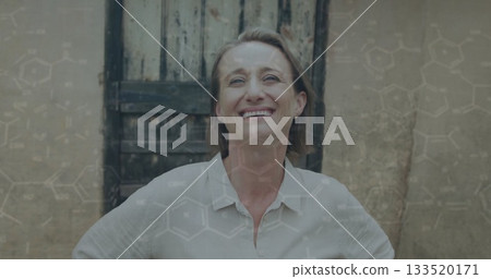 Smiling woman in collared shirt posing before wooden door and plaster wall, with chemical overlay Smiling woman in collared shirt posing before wooden door and plaster wall, with chemical overlay 133520171