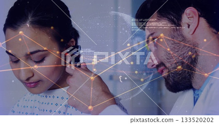 Inspecting doctor in white coat examining patient's ear in clinic, with otoscope and data overlay 133520202