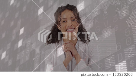 Smiling female scientist wearing lab coat clasping hands in studio with floating data codes and map 133520203