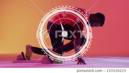 Positioning athlete kneeling in starting blocks under gradient lights, with running shoes, red top Positioning athlete kneeling in starting blocks under gradient lights, with running shoes, red top 133520223