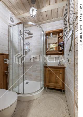 Small bathroom with wooden furniture and glass shower cabin 133522365