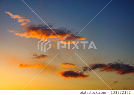 Red clouds floating in the western sky just before sunset Red clouds floating in the western sky just before sunset 133522392