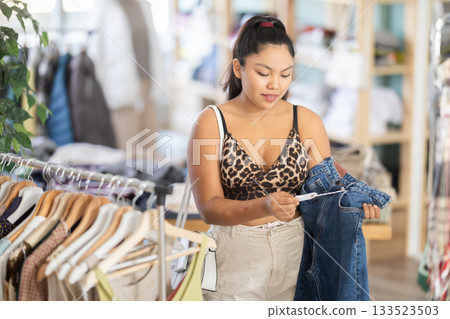 Girl at trading floor pick out and buying jeans trousers 133523503
