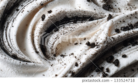 Swirled vanilla ice cream with dark cookie crumbles and a creamy texture 133524718