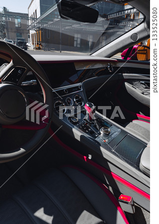 Modern luxury car interior with sleek design and vibrant accents in urban setting 133525080