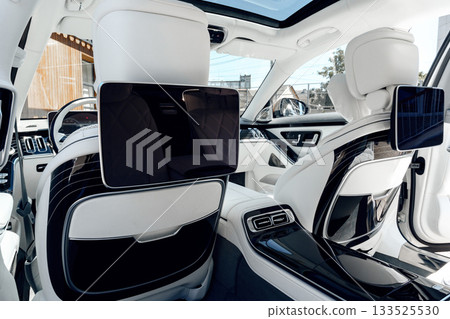 Luxury car interior showcasing advanced entertainment screens and spacious seating design Luxury car interior showcasing advanced entertainment screens and spacious seating design 133525530