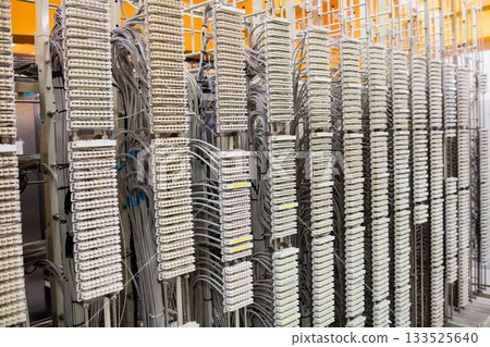 Flat design illustration is showing telecommunication racks with terminal blocks and grey cables Flat design illustration is showing telecommunication racks with terminal blocks and grey cables 133525640