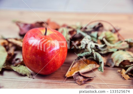 Apple and leaves on table 133525674