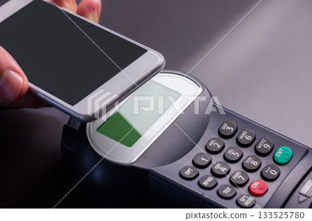 Man using smartphone to express pay Man using smartphone to express pay 133525780