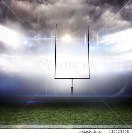 Football goalpost standing on grass turf field in flat design, floodlights glowing under cloudy sky 133525868