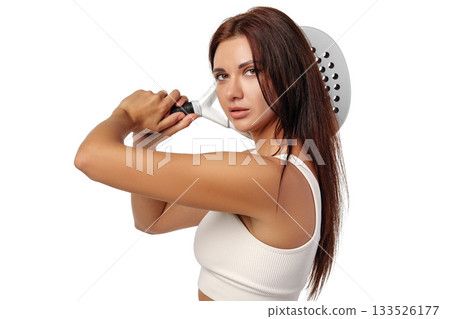 Woman posing confidently with a large kitchen utensil in a bright setting Woman posing confidently with a large kitchen utensil in a bright setting 133526177