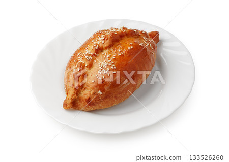Savory pastry filled with delicious ingredients served on a white plate 133526260