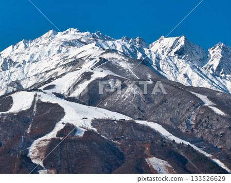 Happo-one Ski Resort, Mt. Karamatsu, and Mt. Fukiya no Tsurugi in early winter, Hakuba Village, Nagano Prefecture (aerial shot by drone) Happo-one Ski Resort, Mt. Karamatsu, and Mt. Fukiya no Tsurugi in early winter, Hakuba Village, Nagano Prefecture (aerial shot by drone) 133526629