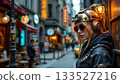 A person stands prominently in an urban setting, dressed in a steampunk style outfit with goggles and a large helmet 133527216