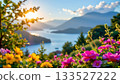 A serene landscape where a vibrant carpet of pink flowers stretches across a hillside in the foreground 133527222