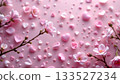 A close up of delicate pink cherry blossom petals scattered across a white surface with soft focus, creating an ethereal effect. 133527234