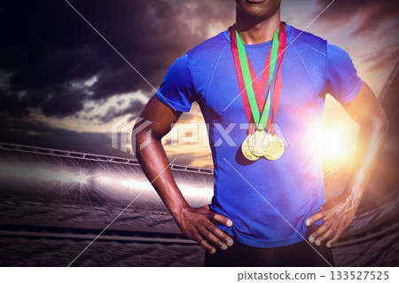 Midsection of male athlete standing at stadium Midsection of male athlete standing at stadium 133527525