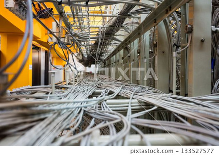 Dense grey network cables are weaving through metal cable trays in flat design infrastructure scene Dense grey network cables are weaving through metal cable trays in flat design infrastructure scene 133527577