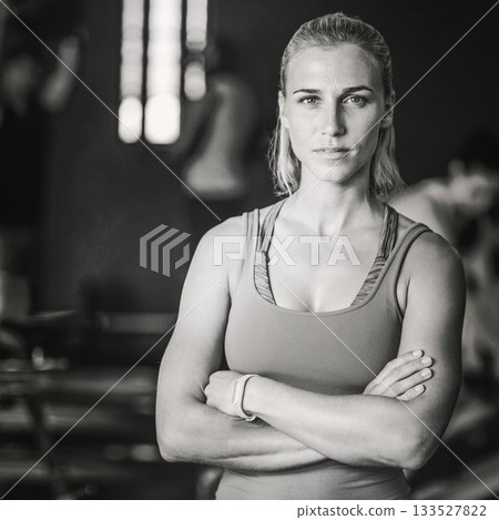 Young woman with arms crossed standing at gym 133527822