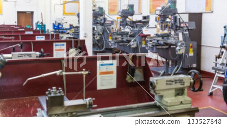 Flat design bench lathes are lining workshop area, featuring red partitions and instruction posters Flat design bench lathes are lining workshop area, featuring red partitions and instruction posters 133527848