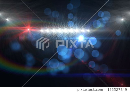 Starburst lights and lens flares are shining over black void in abstract design with blue bokeh 133527849