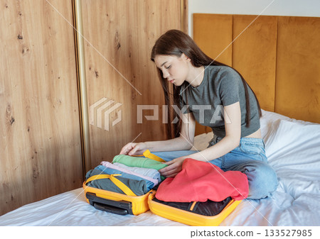 Woman preparing suitcase for travel packing vacation 133527985