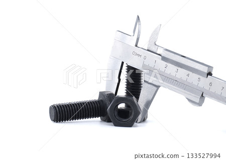 Caliper measuring a bolt, showcasing precision and engineering concepts. Caliper measuring a bolt, showcasing precision and engineering concepts. 133527994