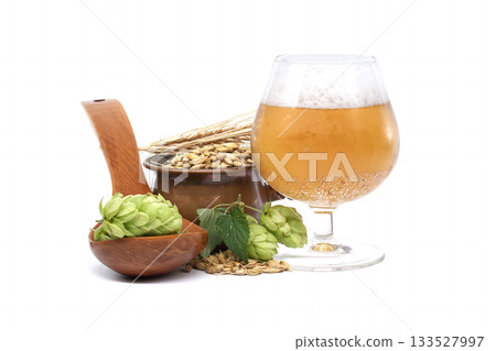 Beer ingredients and a glass of beer on a white background. 133527997