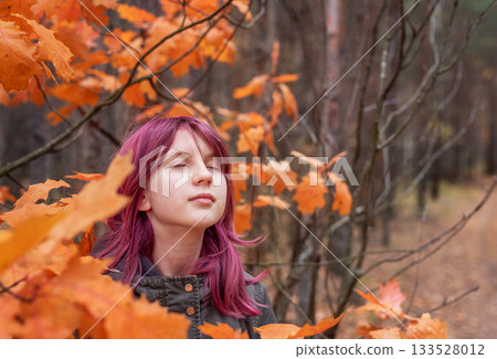 Girl enjoying autumn forest with colorful pink hair Girl enjoying autumn forest with colorful pink hair 133528012