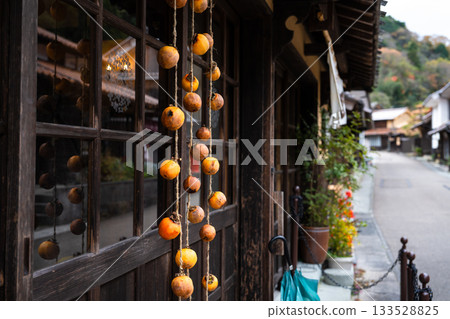 Dried persimmons under the eaves (Iwami Ginzan, Omori area) 133528825