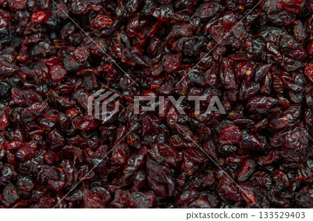 Dried cherries as a background. A top view close-up of dehydrated cherries, ripe berries. The texture of the berries and food as a background Dried cherries as a background. A top view close-up of dehydrated cherries, ripe berries. The texture of the berries and food as a background 133529403
