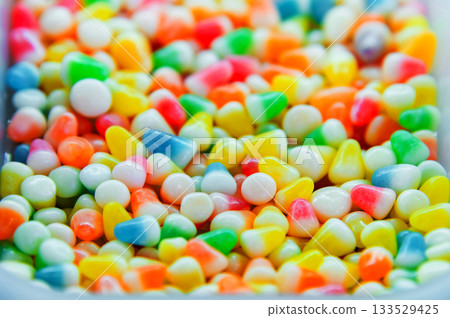 Colorful background of multicolored, shiny, round, chewy candies. A background photo of colorful sweets. A close-up photo of the candies taken in a candy store Colorful background of multicolored, shiny, round, chewy candies. A background photo of colorful sweets. A close-up photo of the candies taken in a candy store 133529425
