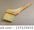 Close-up of art tools lined up with well-used paintbrushes 28 133529434